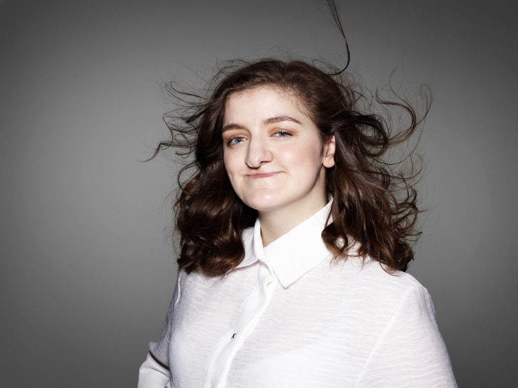 Rhona in a white top posing for the Portrait Positive photo shoot by Rankin