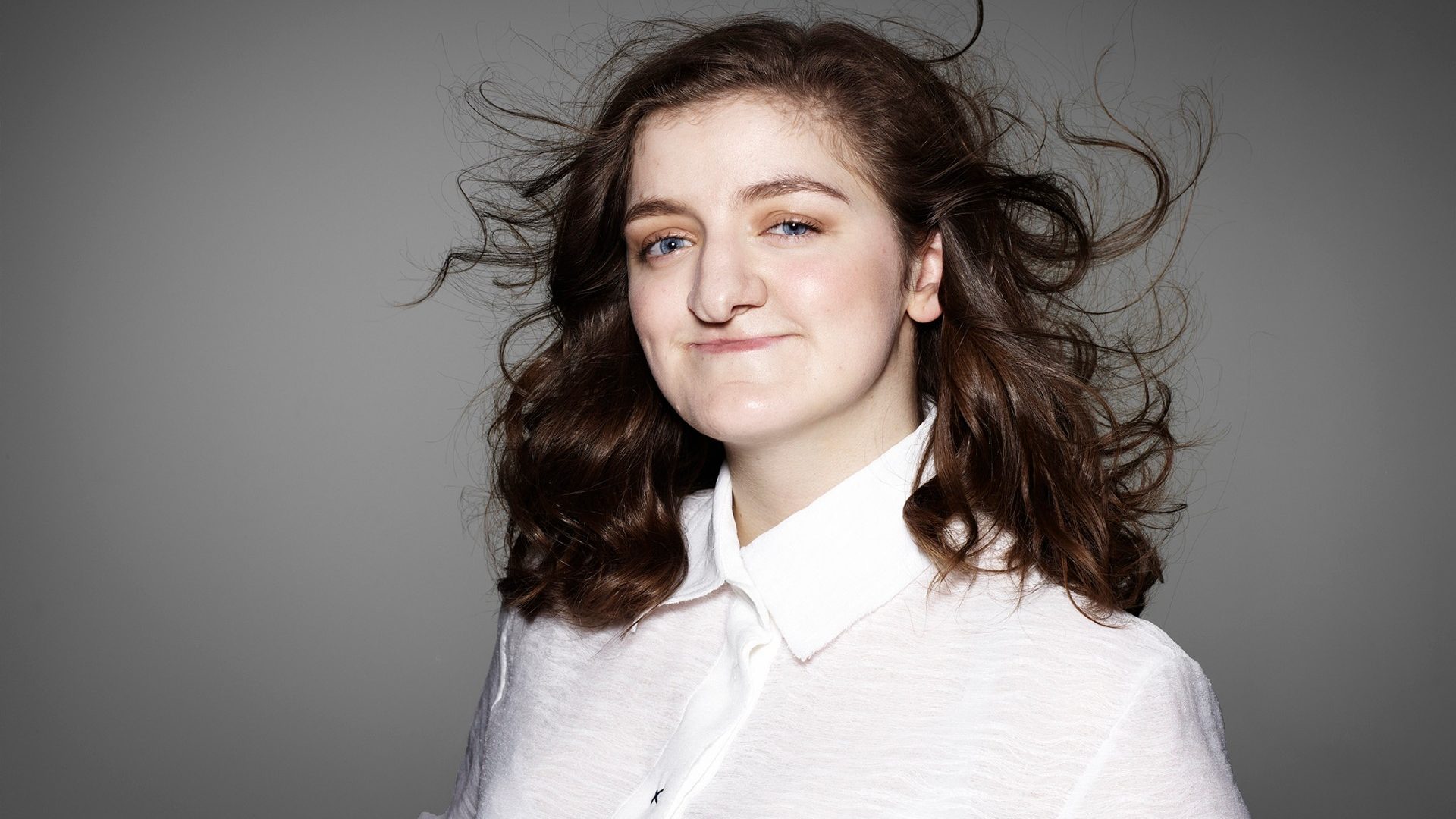 Rhona in a white top posing for the Portrait Positive photo shoot by Rankin