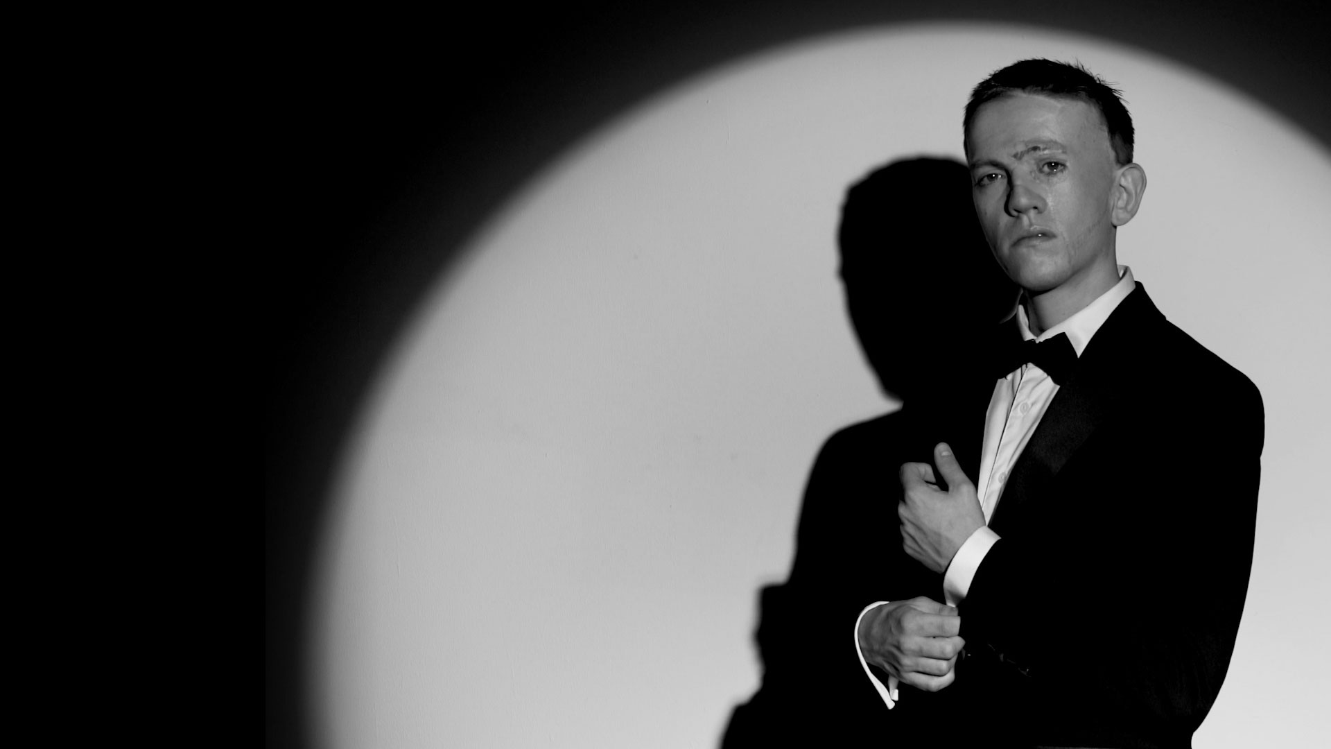 A person with a visible difference dressed as James Bond in the opening title sequence