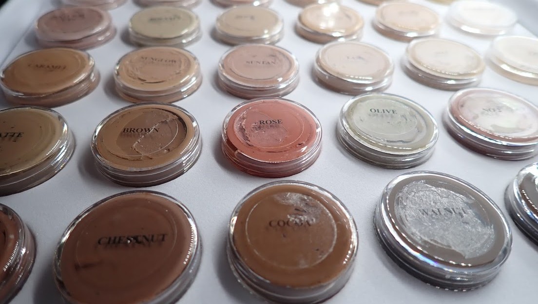 A palette of skin camouflage creams showing a range of colours and shades