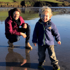 Marie-Joelle and her son Benjamin smile whilst on the beach