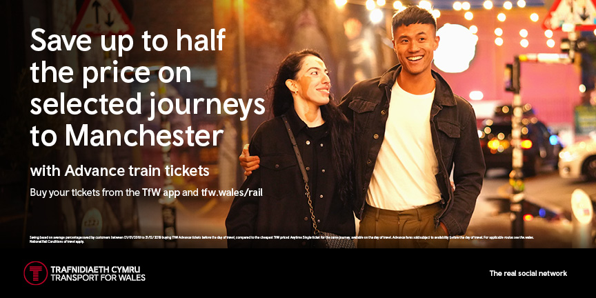A landscape train advert featuring a person with vitiligo. It's advertising half price train journeys to Manchester.