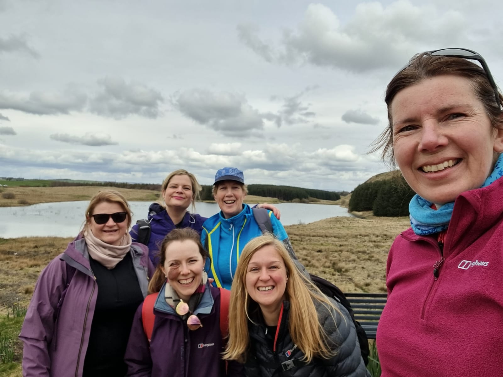 Monica and a few of her teammates on a practice hike. They're surrounded by beautiful countryside.