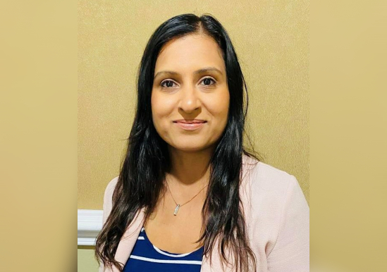 Director of Fundraising and Communications Pushpinder Gill wears striped top and pale cardigan