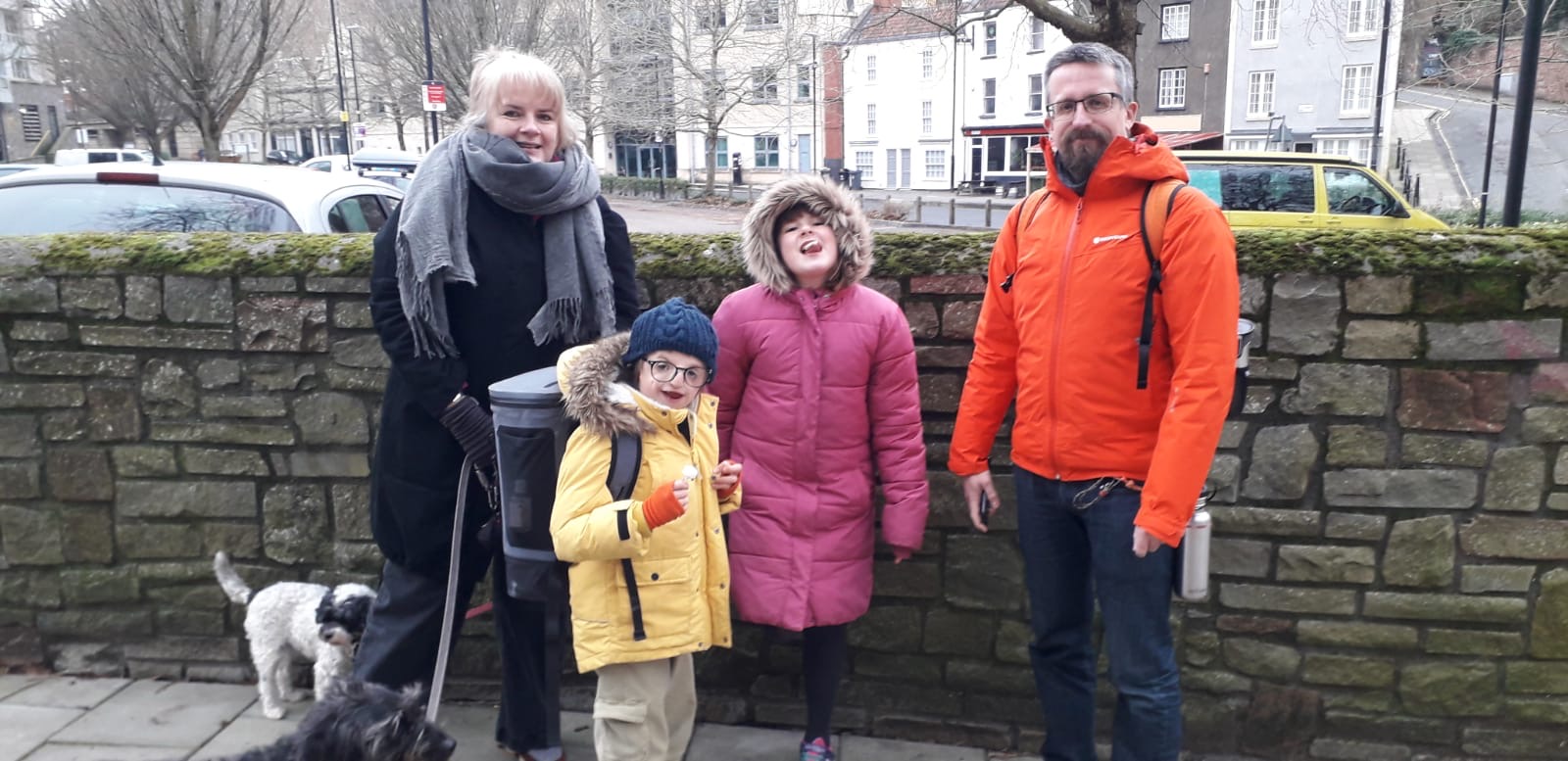 William, who has been living with Teacher Collins syndrome from birth, stands with his mom, dad and sister