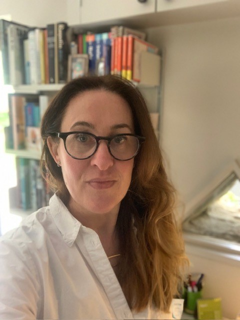 Louise Wright CEO of Changing Faces wearing glasses and a white shirt