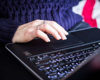 Someone typing on a laptop