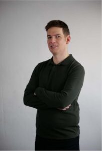 Gary looking at the camera with his arms crossed