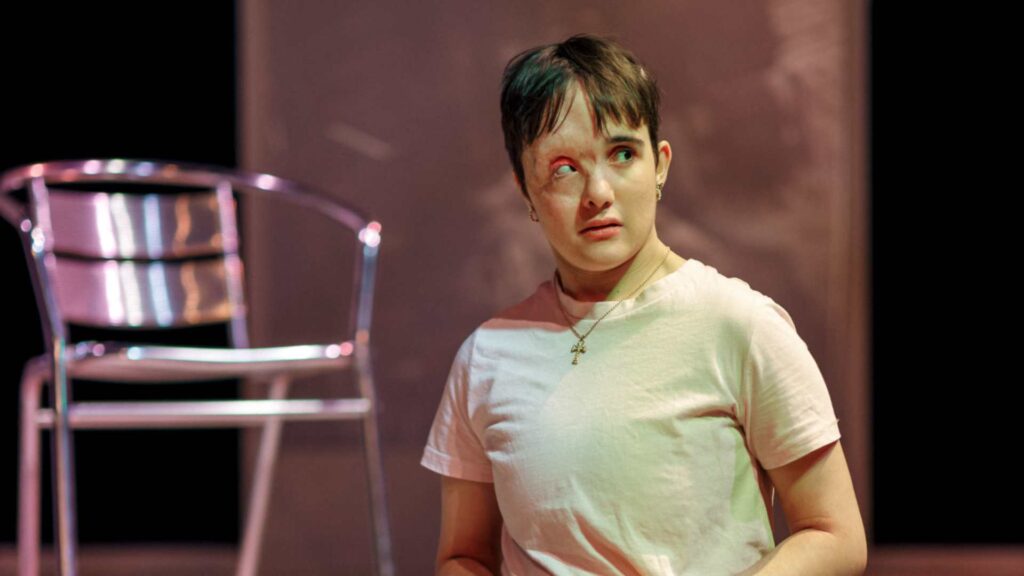 Beau acting in a play with a visible differemce. They look off to the side with a worried expression.